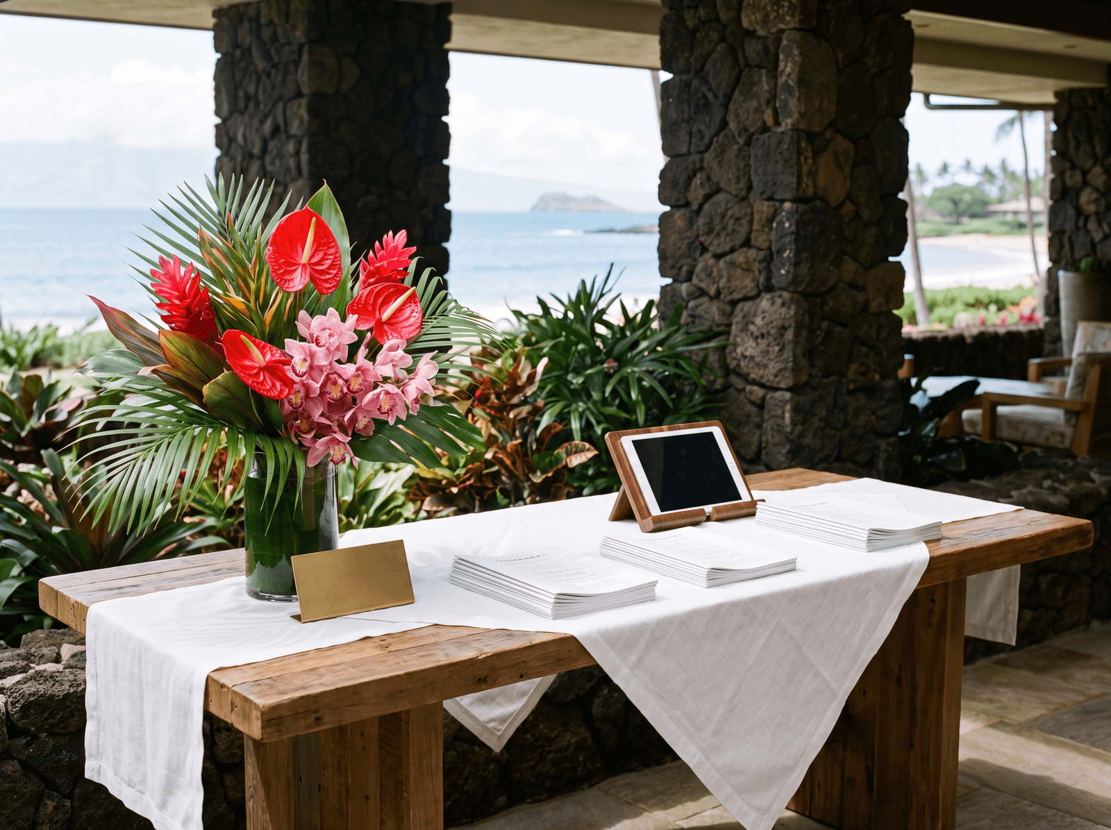 Hospitality desk with orchids and printed itineraries in an open-air lobby