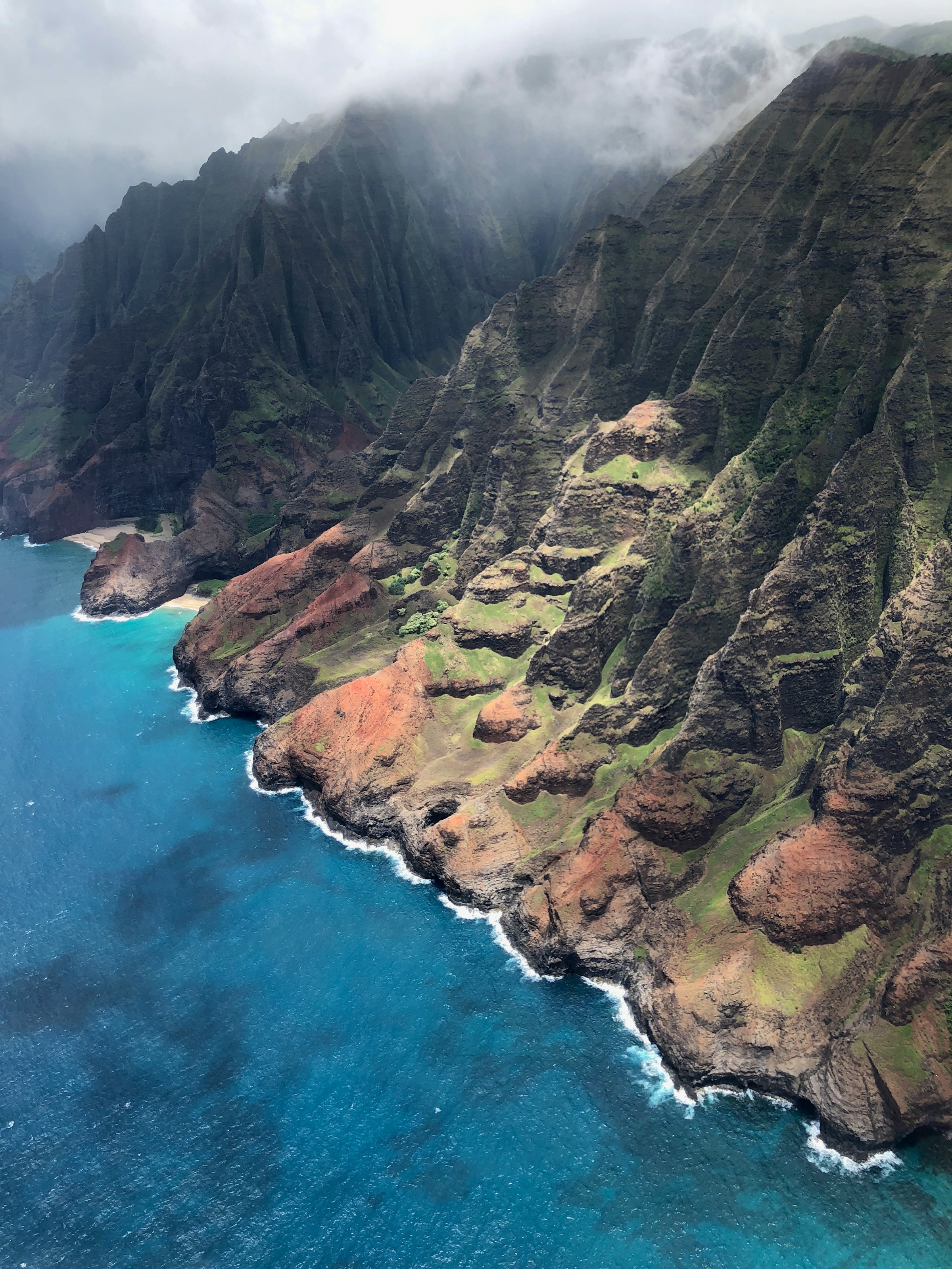 Dramatic cliffs and blue ocean along Kauaʻi’s Nā Pali Coast